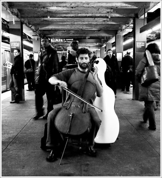 Dale Henderson playing cello in a New York City subway station